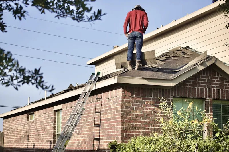 Professional roofer working on a residential roof in Detroit